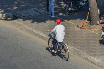 A man biking on street in Saigon, Vietnam