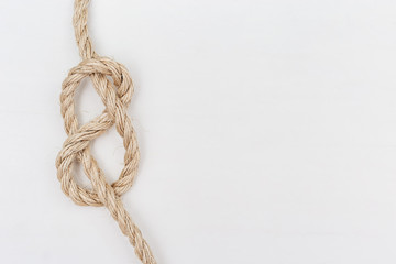 Figure-eight knot or Flemish knot on light rope. Copy space.