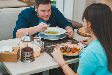 couple having lunch in mall cafe together. date talking