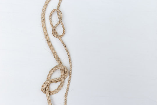 Rope knot on white background. Copy space.
