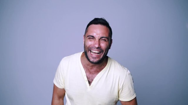 Man laughing loudly and pointing finger at camera