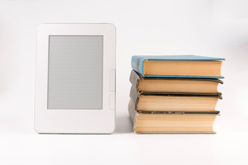 Electronic book with stack of regular old books isolated on white background