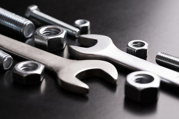 Nuts and wrench bolts on a dark background