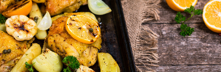 Roasted Chicken with Potatoes and Meyer Lemon. Selective focus.