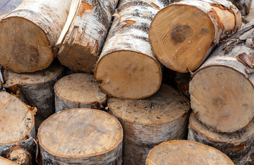 Fototapeta premium Stacked firewood as background, closeup. Heating house in winter