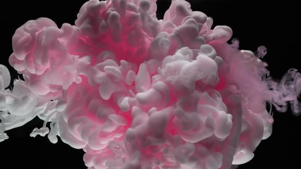 Super slow motion of coloured inks in water. Isolated on black background. Filmed on high speed cinema camera.