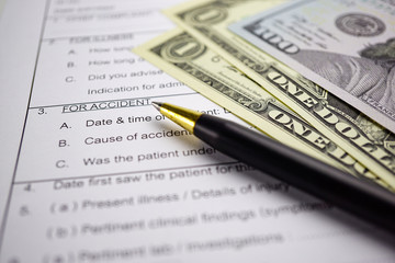 Health insurance accident claim form with coin money and car.      