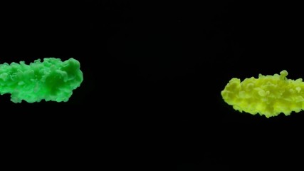 Super slow motion of coloured inks in water. Isolated on black background. Filmed on high speed cinema camera.