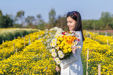 Beautiful attractive girl with colorful flower in park
