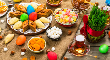 Colored eggs, wheat springs and sweet pastry for Nowruz Holiday in Azerbaijan. Selective focus.