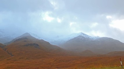 Snow is falling in the highlands of scotland