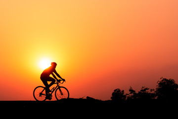 Obraz premium ride a bicycle ,silhouette background.