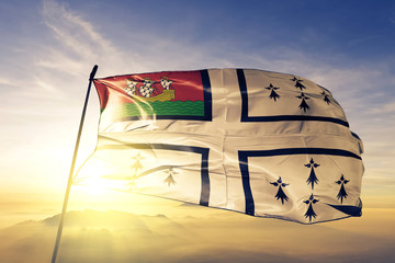 Nantes city of France flag waving on the top sunrise mist fog