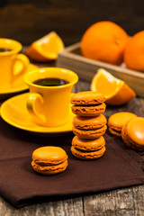 Orange French Macarons with Dark Chocolate and Coffee Filling. Selective focus.