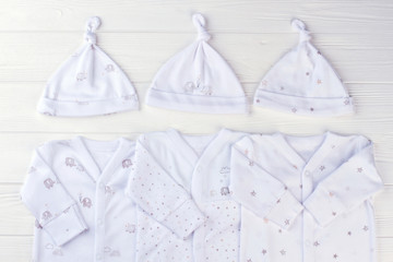 Sets of pajama newborn baby sleepwears with knot hats.