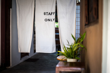 Staff only sign, at the door made from white fabric to keeping confidential