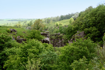 Beautiful Ukrainian landscape. Rocky mountains and green forest.