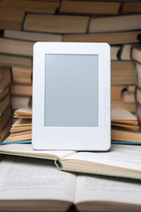 Fototapeta premium Electronic book on background of regular old books