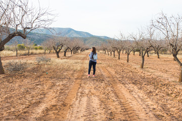 Travel, summer and people concept - woman with stylish backpack on nature background. She is on holiday