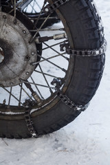 Motorcycle wheel with anti-skid chains for riding in snow