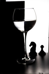 Glass of water with overlap in the form of a chessboard concept