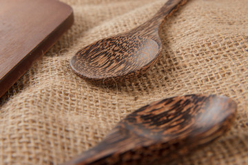 Wooden spoons close up near to the cutting board