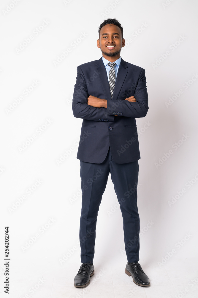 Poster full body shot of happy young african businessman with arms crossed