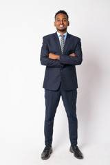 Full body shot of happy young African businessman with arms crossed - 254202744