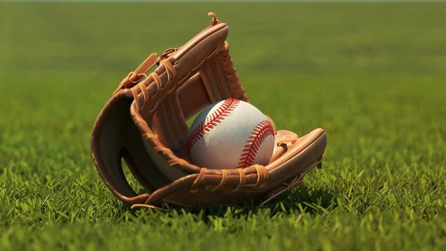 Vintage leather baseball glove with a ball lying down on a fresh stadium grass.