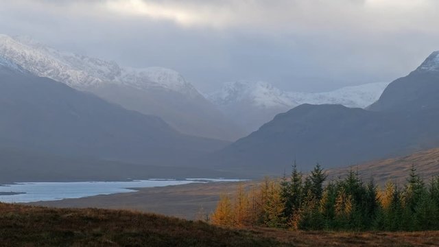 Snow is falling in the highlands of scotland