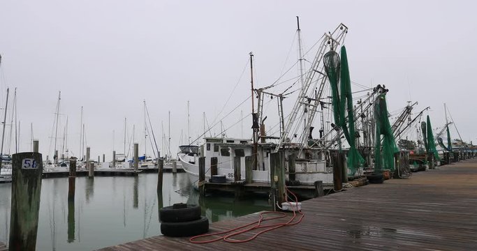 Fishing trawler boats Corpus Christi Texas harbor. South Texas tourism travel destination. Waterfront marina, port harbor and scenic byway.  Humid subtropical climate makes a year round vacation city.