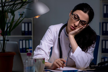 Young female doctor working at night shift 