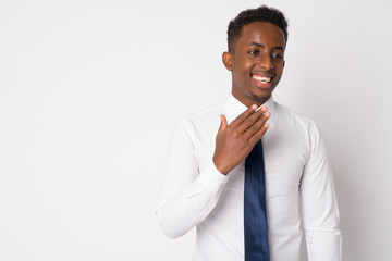 Portrait of happy young African businessman thinking and laughing