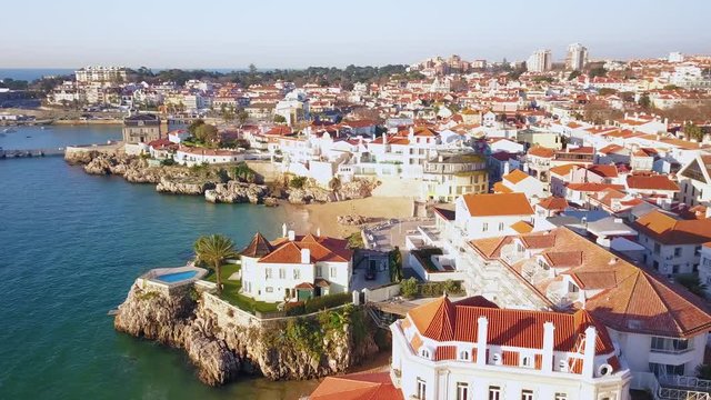 Aerial, pan, drone shot, around the cityscape, overlooking Palacio Seixas, Marina de Cascais and the coast of the Atlantic sea, in Cascais, Portugal