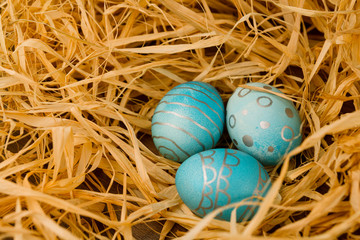 Fototapeta na wymiar Easter eggs lie in the hay. Holiday concept