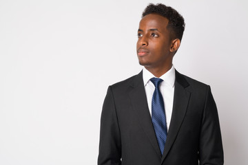 Portrait of young African businessman in suit thinking