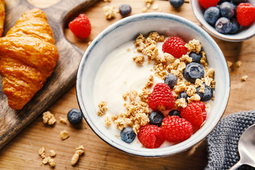 Yogurt with berries and granola in bowl