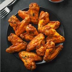 Chicken wings grilled in sauce on plate