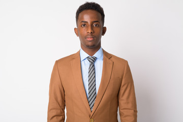 Portrait of young African businessman in brown suit