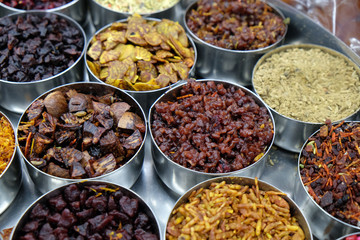 Different spices and herbs in metal bowls on a street market in Kolkata, West Bengal, India