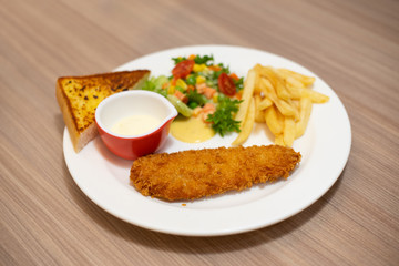 Fried salmon steak and appetizer on the table