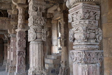 Columns with stone carving in courtyard of Quwwat-Ul-Islam mosque, Qutab Minar complex, Delhi, India 