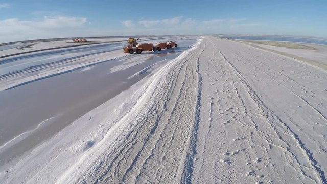 Aerial shot of a large truck before being filled with salt in the salt flats by solar evaporation in Guerrero Negro, Ojo de Liebre lagoon, Biosphere Reserve of El Vizcaino, Baja California