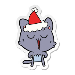 sticker cartoon of a cat singing wearing santa hat