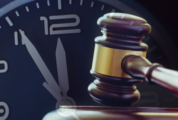 Wood and brass gavel on its base with clock dial