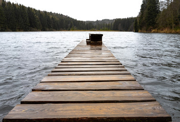 Pier going into a lake at stormy weather