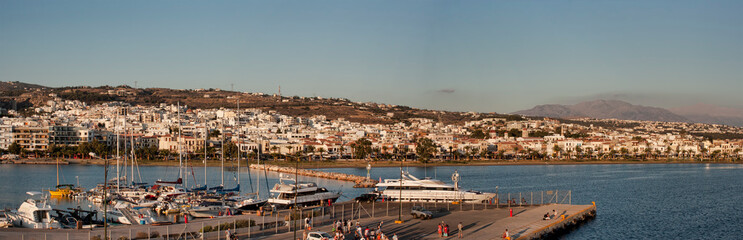 Fototapeta na wymiar Port of Rethymno, panoramic view from the deck of the ferry in the early morning