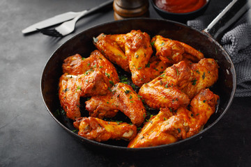 Chicken wings grilled in sauce on pan
