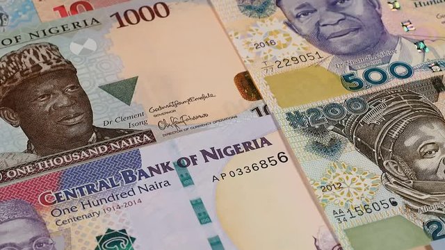 Nigeria naira notes rotating. Nigerian money, currency. Low angle. Stock video footage