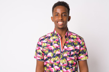 Portrait of happy young African tourist man with Afro hair smiling